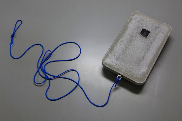 Larissa Mühlrath: mobile but broken or broken but mobile, 2017, object, 
concrete, smartphone part, double rollers with thread, eye bolt, rope, 55 x 33 x 9 cm

